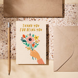 friendship card with a hand holding colorful flowers and a text that says thank you for being you  Edit alt text