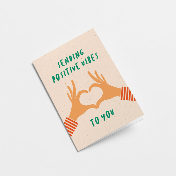 greeting card with two hands creating heart shape with fingers and a text that says sending positive vibes to you  Edit alt text