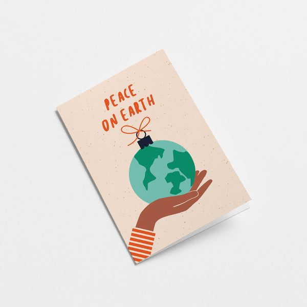 greeting card with gift wrapped earth on the palm of a brown hand with a text that says peace on earth  Edit alt text