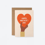 mothers day card with a black hand holding a big red heart and a text that says happy mothers day