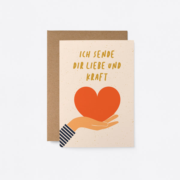 German Sympathy card with a hand holding a red heart and text that says Ich sende dir Liebe und Kraft