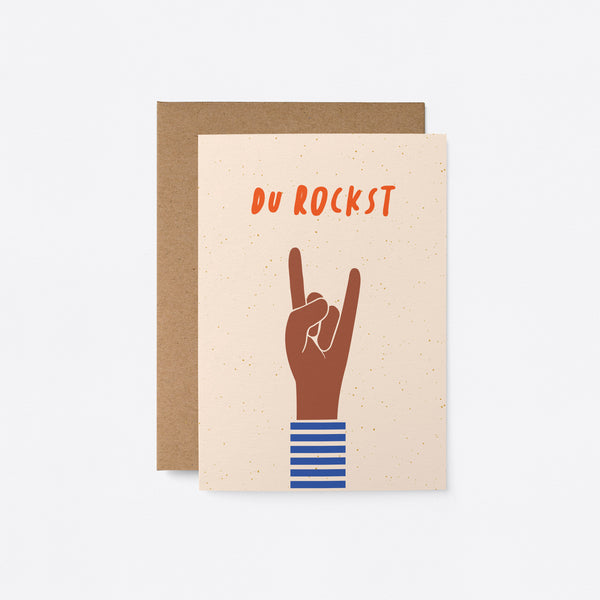 German birthday card with a brown hand and a gesture of sign of the horns with a text that says Du rockst