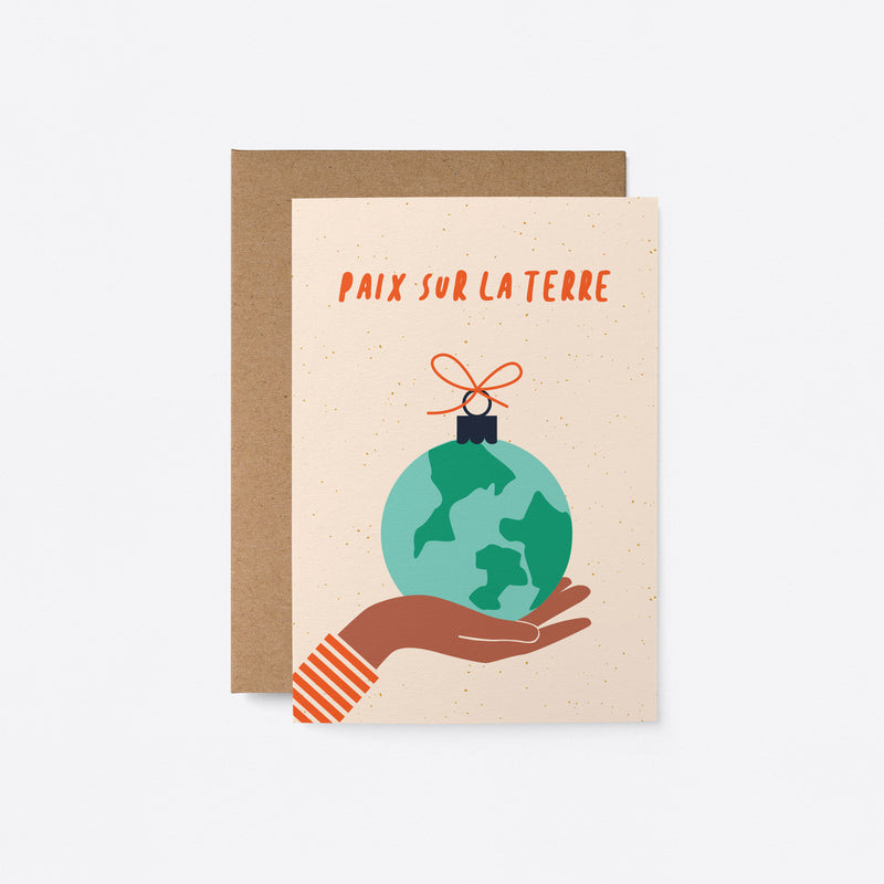 french greeting card with gift wrapped earth on the palm of a brown hand with a text that says Paix sur la Terre