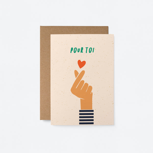 french love and friendship card with a hand making finger snap gesture and a red heart above it with a text that says Pour toi