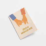 french anniversary card with two hands holding by little fingers and a text that says Joyeux anniversaire  Edit alt text