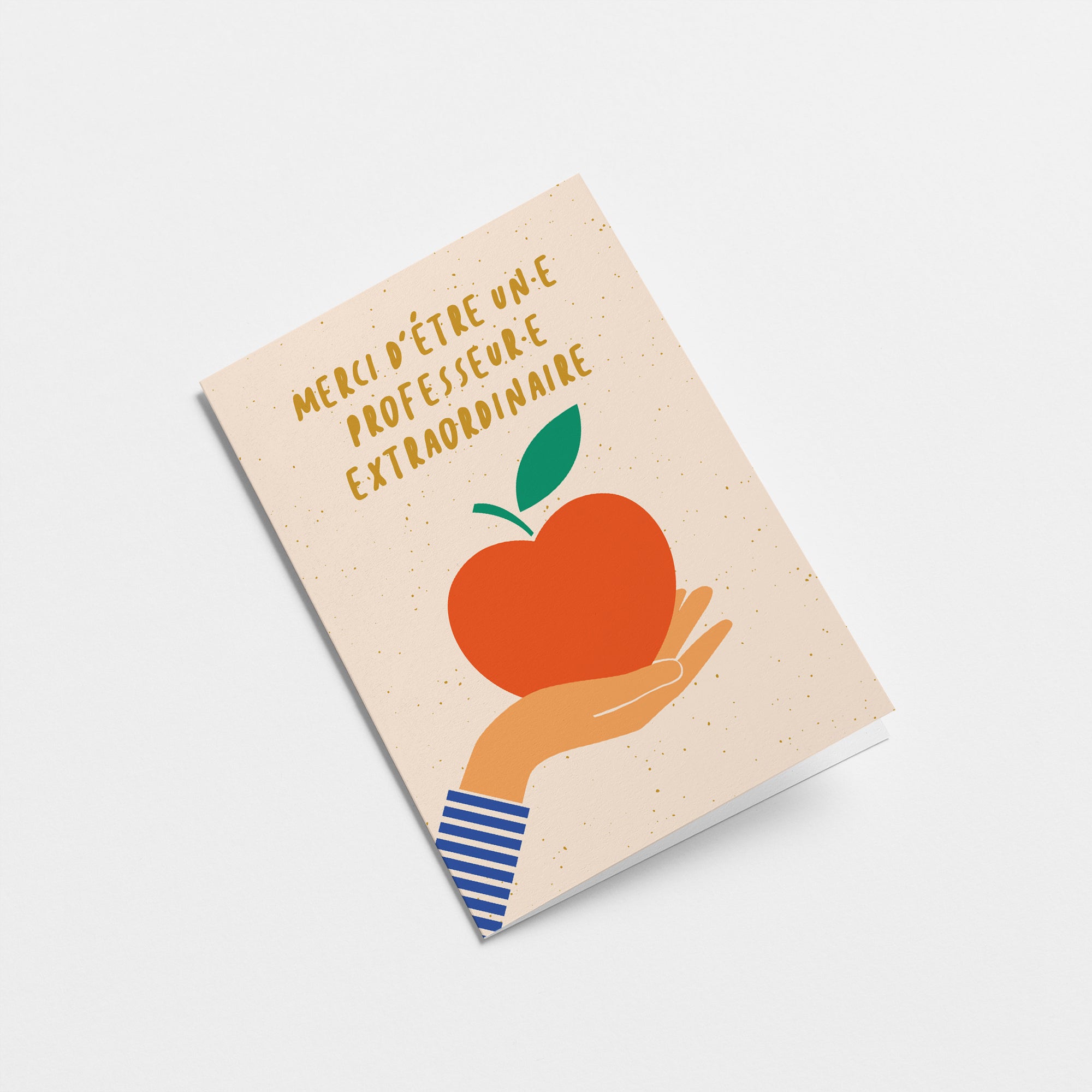 french thank you card with a hand holding a red apple and a text that says Merci d’être un·e professeur·e extraordinaire  Edit alt text