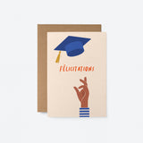french congratulations  graduation card with a black hand throwing blue graduation hat and a text that says Félicitations