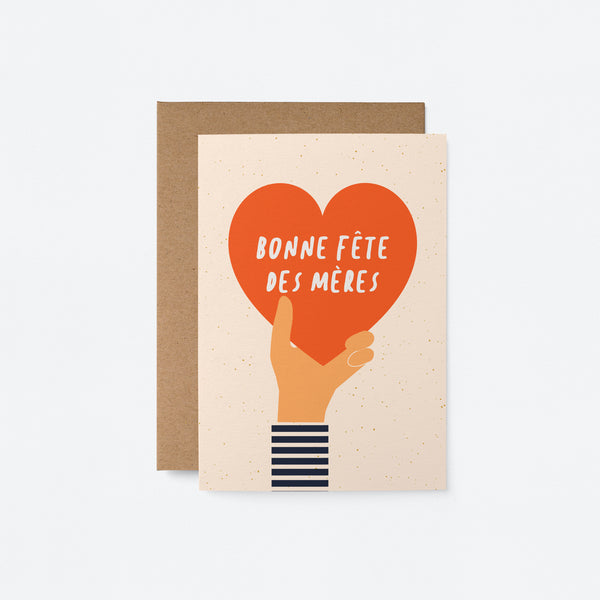 french mothers day card with a hand holding a big red heart and a text that says Bonne fête des mères