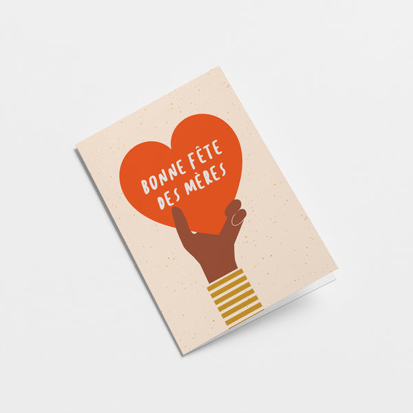 french mothers day card with a black hand holding a big red heart and a text that says Bonne fête des mères  Edit alt text