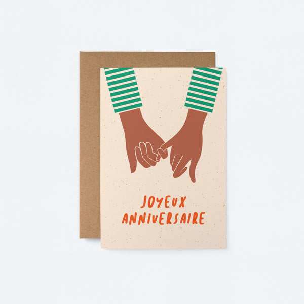 french anniversay card with two black hands holding and a text that says Joyeux anniversaire