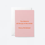 christmas card with a text that says You deserve all the joy in the world. Merry Christmas!